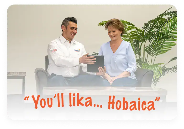 A man in a uniform shows a tablet to a seated woman. They are indoors with plants in the background. Text reads: “You’ll lika... Hobaica.”.