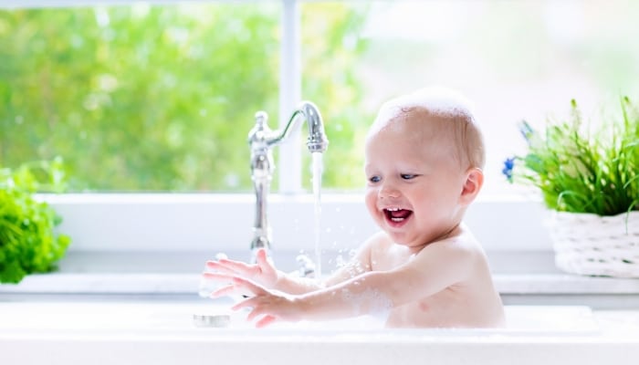 Baby Playing In Sink